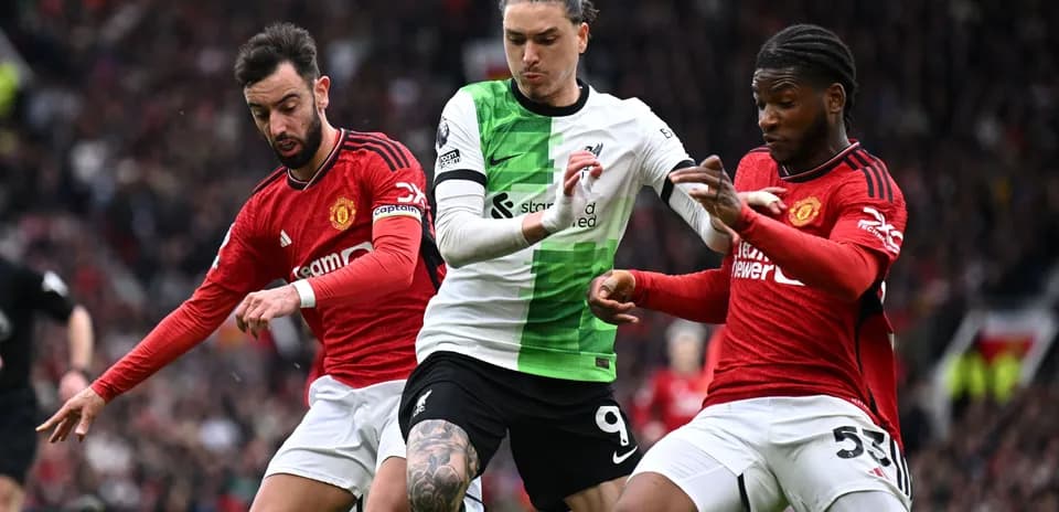 Three players battling for the ball during match