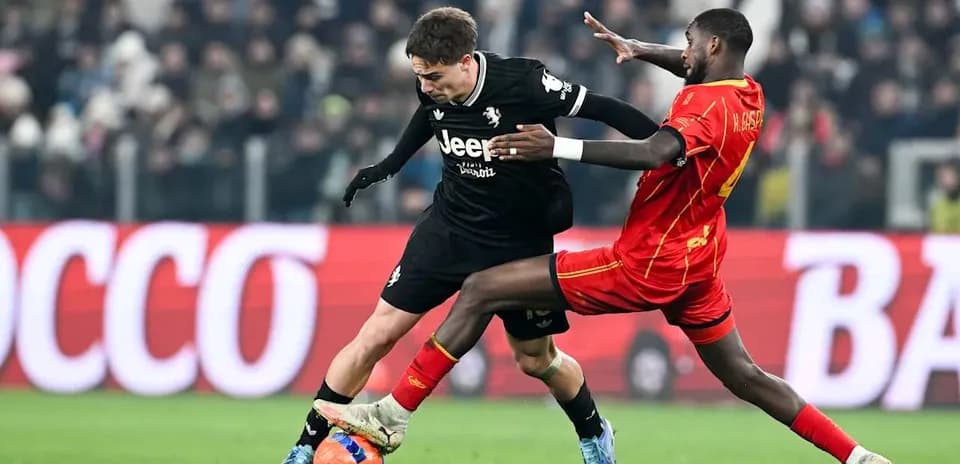 Player tackling opponent during Lecce vs Juventus match