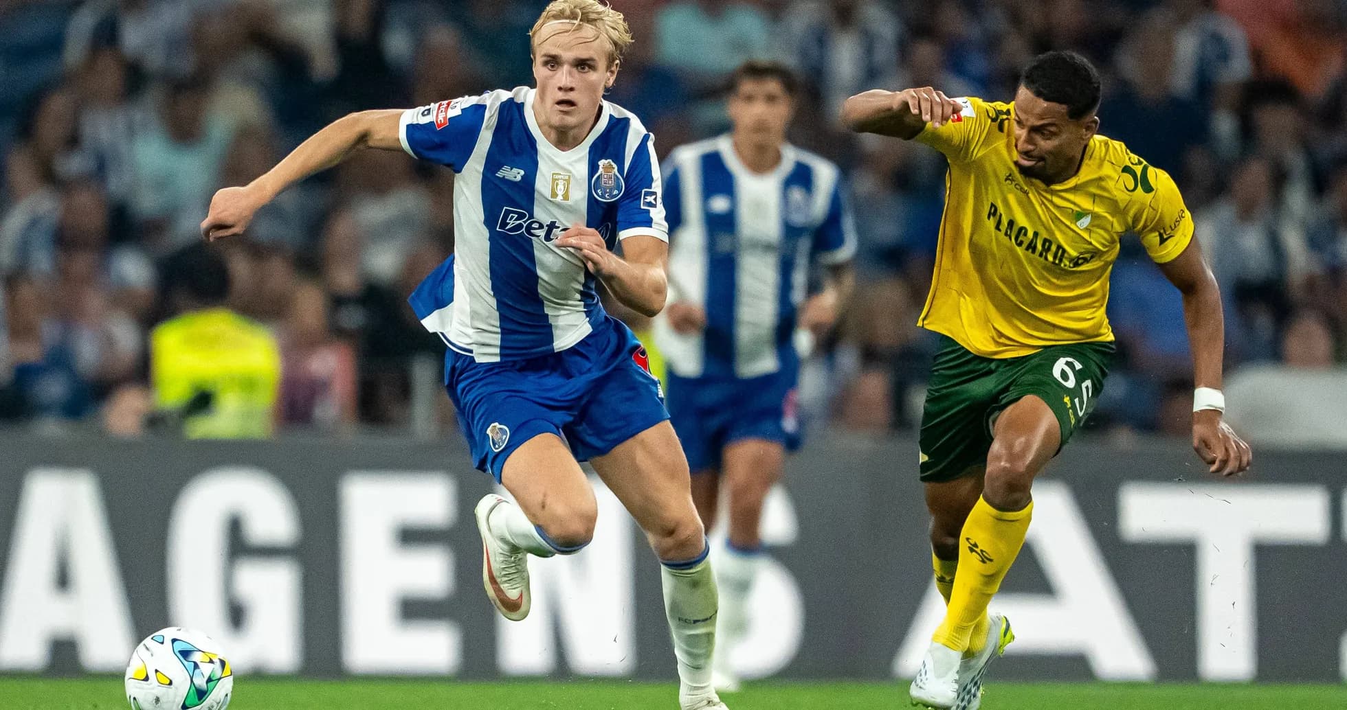 Porto player sprinting with ball, opponent chasing