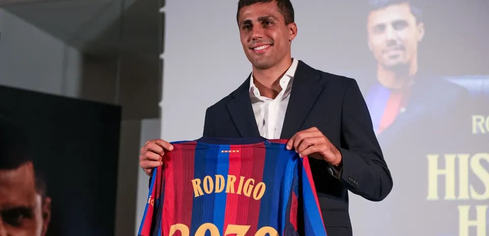 Player holding FC Barcelona jersey at presentation