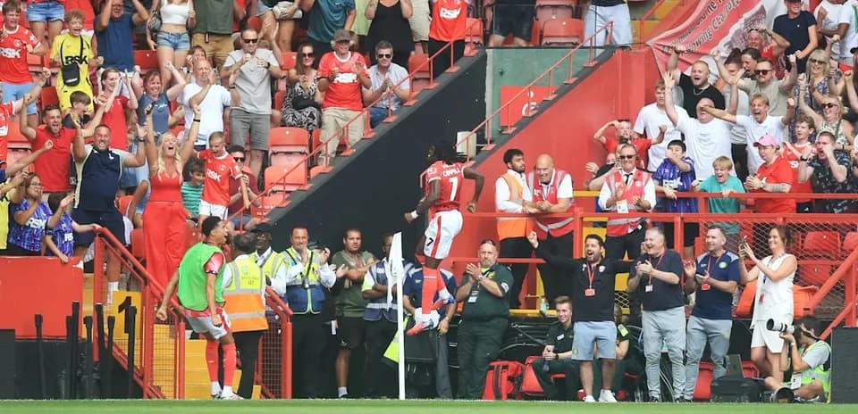 Fans celebrating a goal at the stadium
