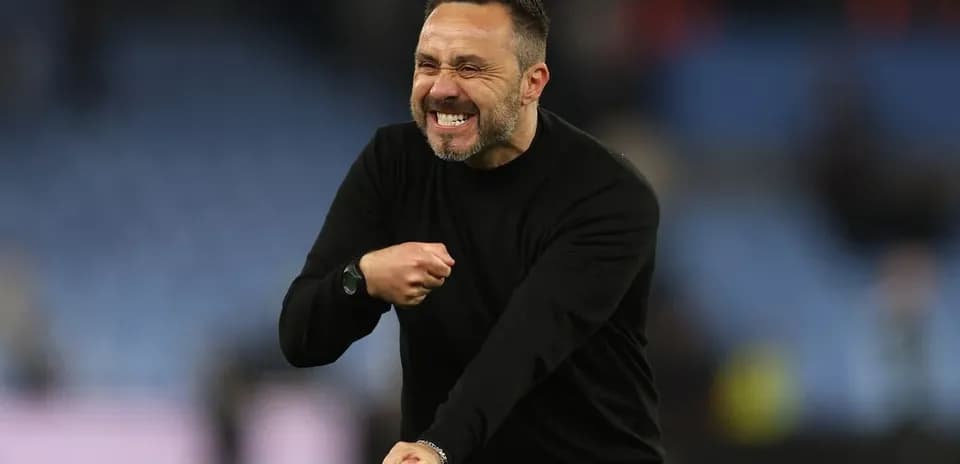 Coach celebrating enthusiastically on the sidelines