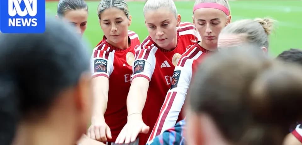 Players in red jerseys huddling before match