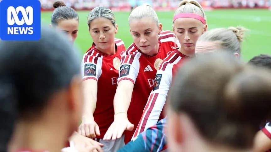 Players in red jerseys huddling before match