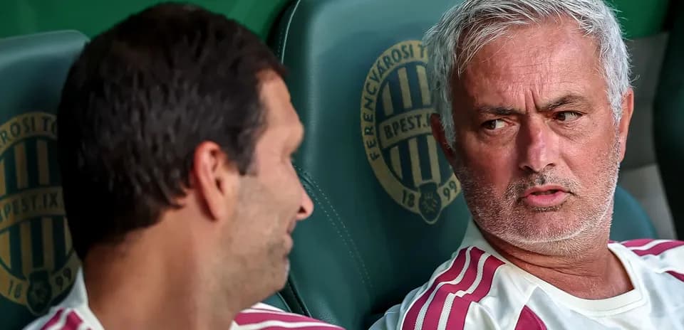 Two coaches discussing on team bench