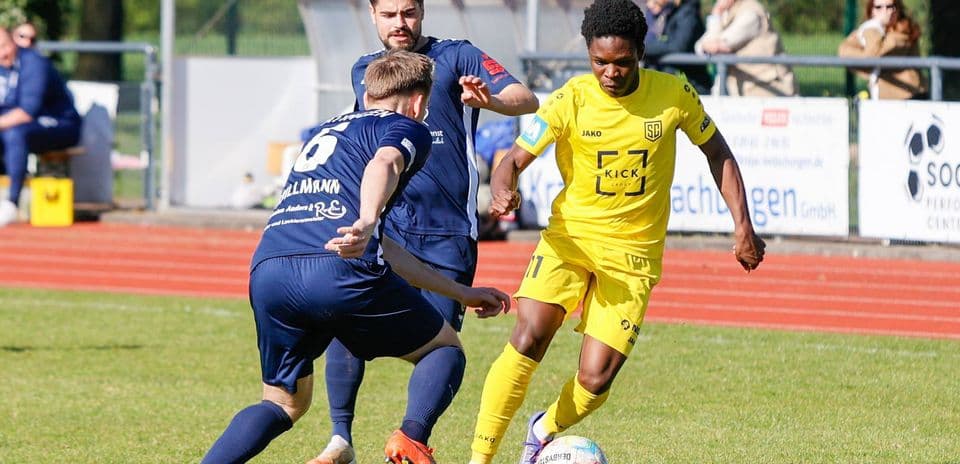 Player in yellow dribbling past opponent in blue