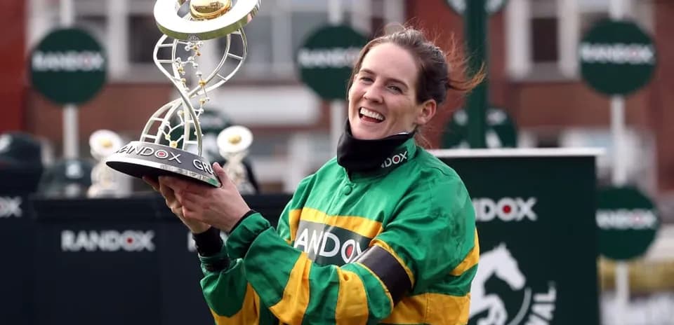 Jockey holding trophy after winning race