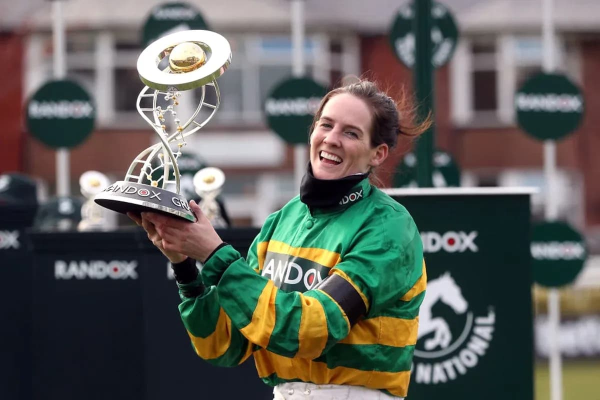 Jockey holding trophy after winning race