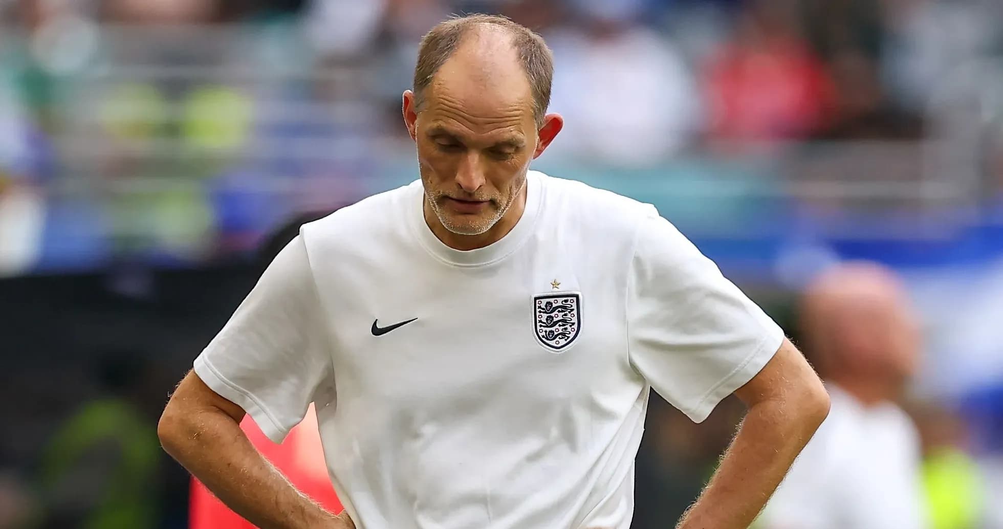 Coach walking with head down during match
