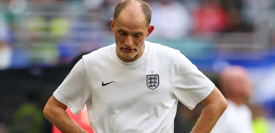Coach walking with head down during match