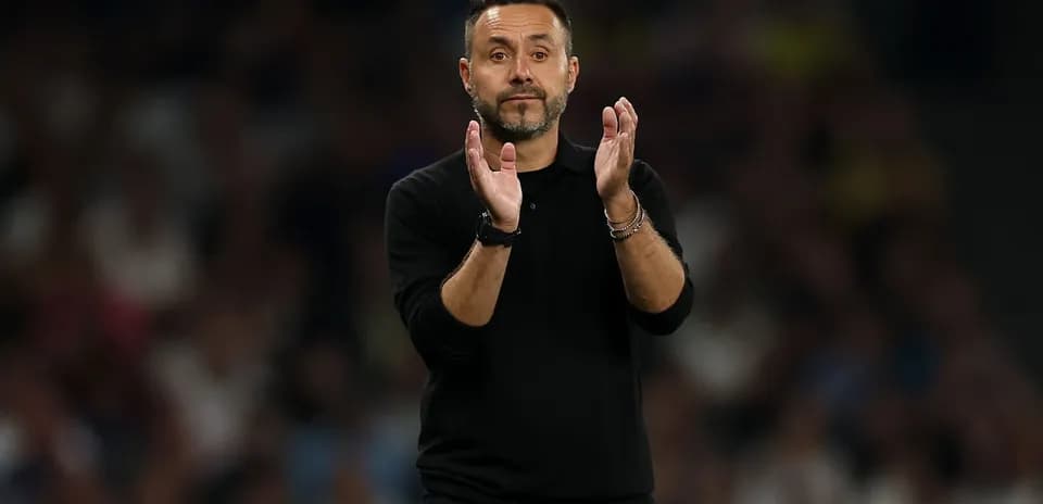 Coach applauding during a match on the sidelines