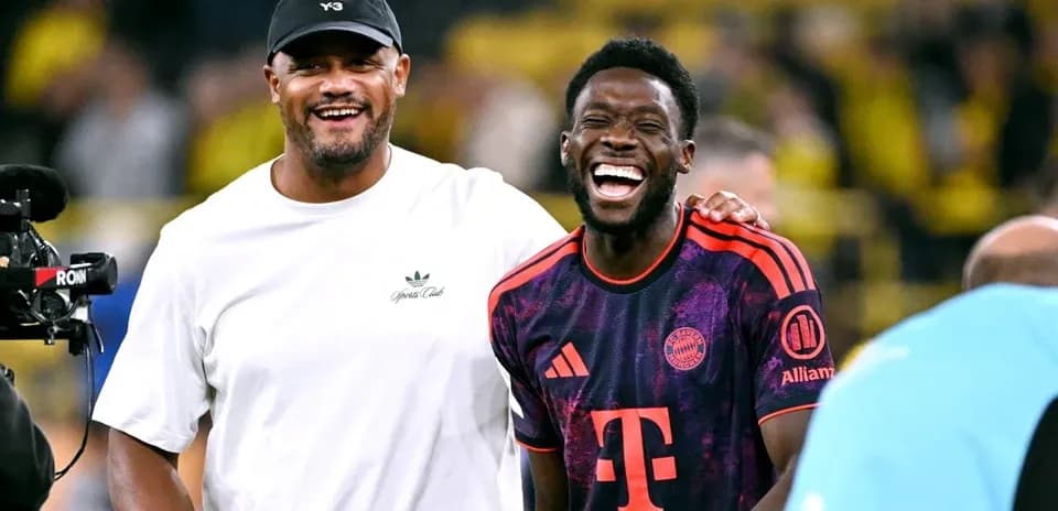 Two men laughing together on the field