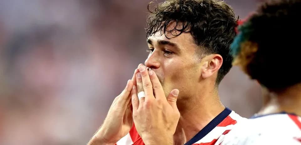 Player celebrating with hands to mouth after match