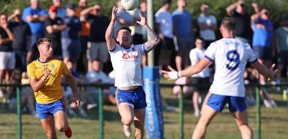 Player catching ball during a match with spectators