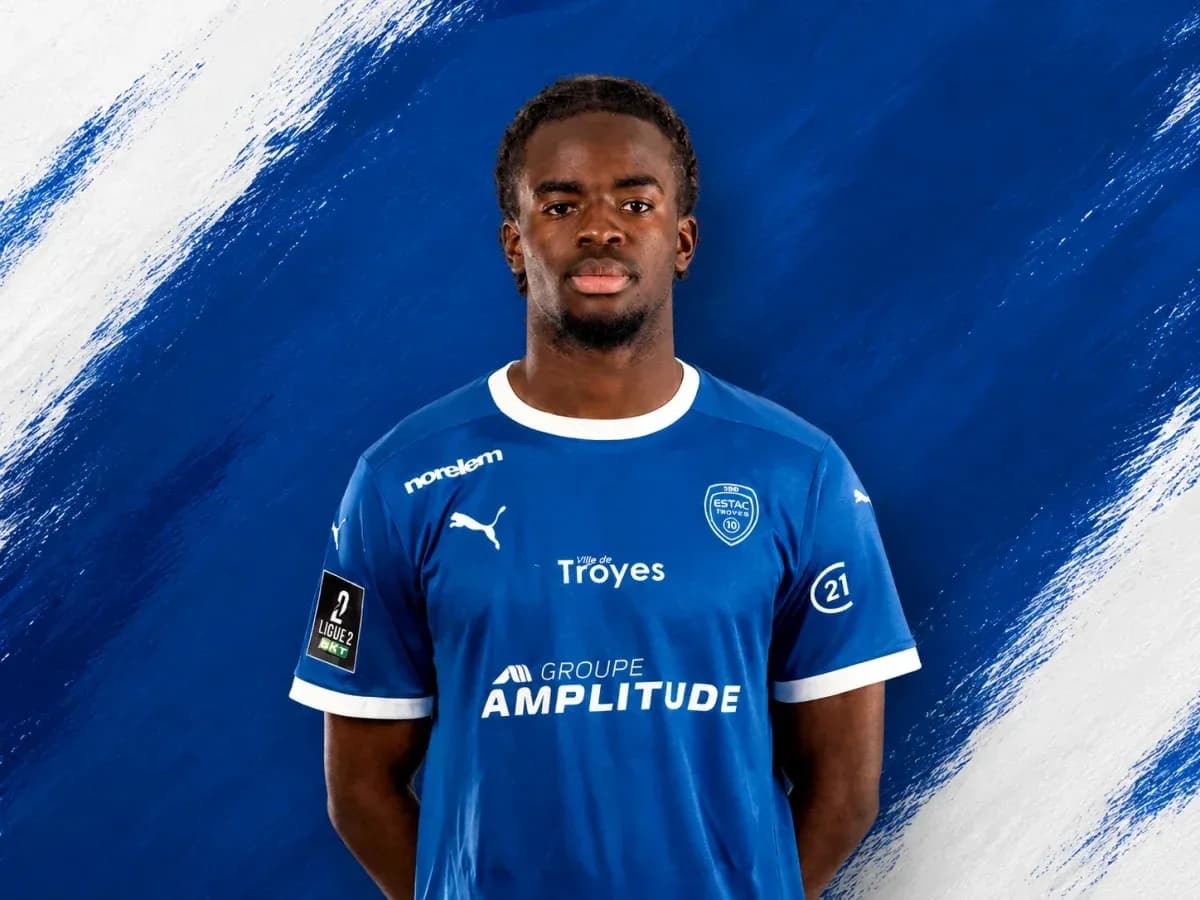 Player in blue ESTAC Troyes jersey posing