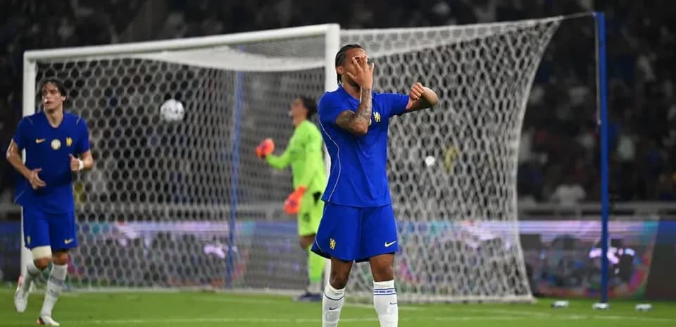 Player in blue jersey reacting during football match
