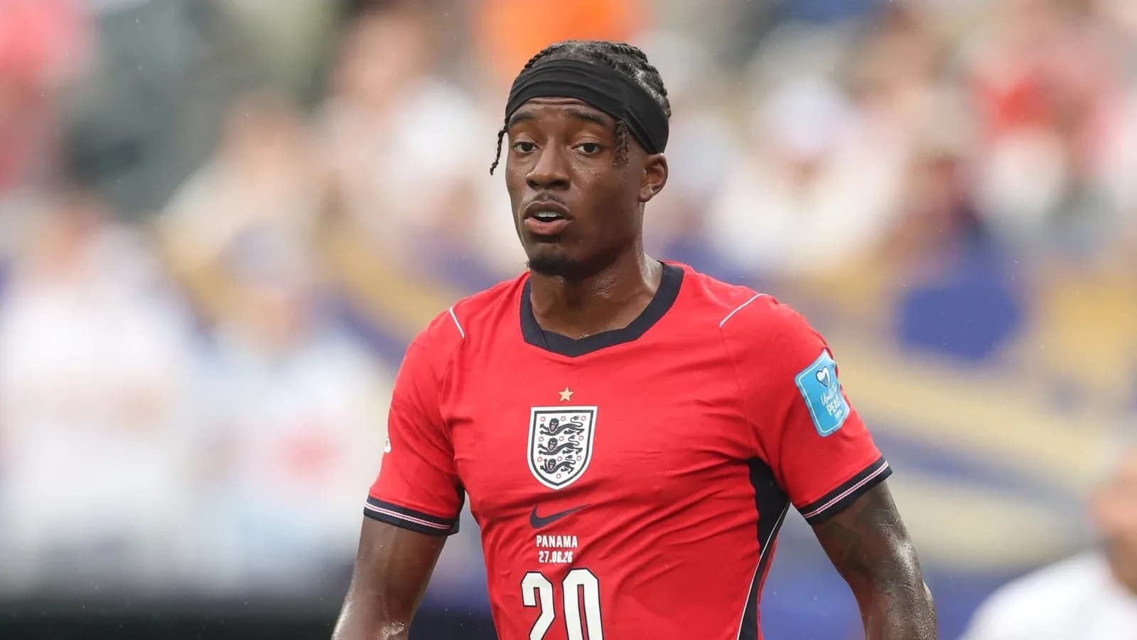 Player wearing red England jersey on the field