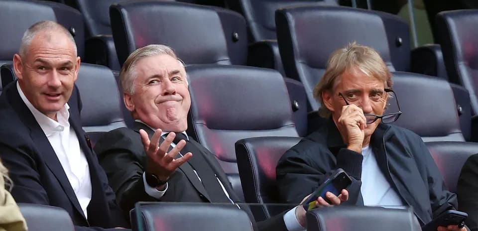 Three men seated in stadium during event