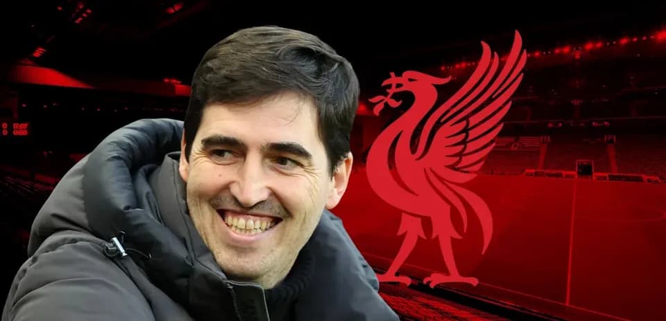 Coach smiling in front of Liverpool stadium background
