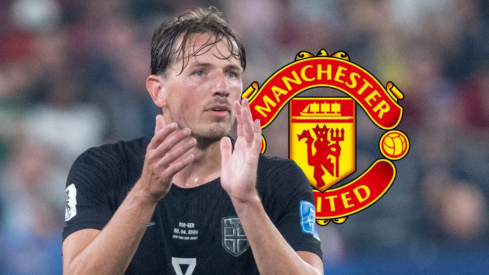 Player in black jersey applauding with Manchester United logo