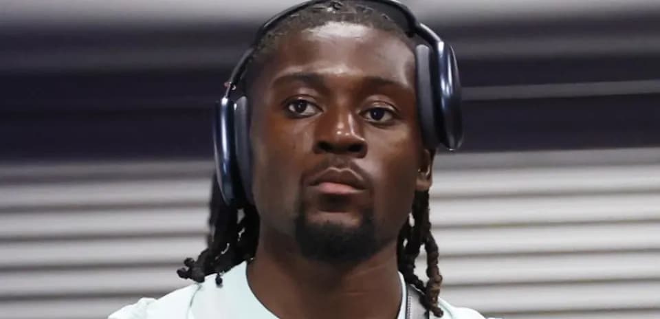 Player wearing headphones, walking in hallway