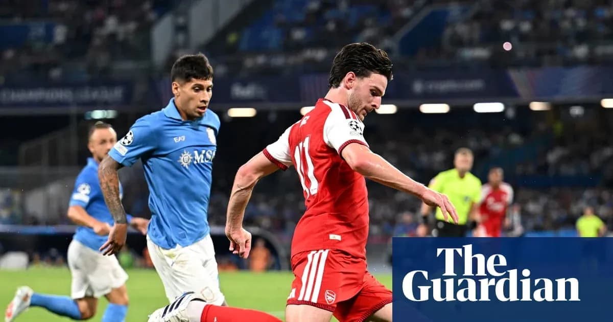 Player in red dribbling past defender in blue
