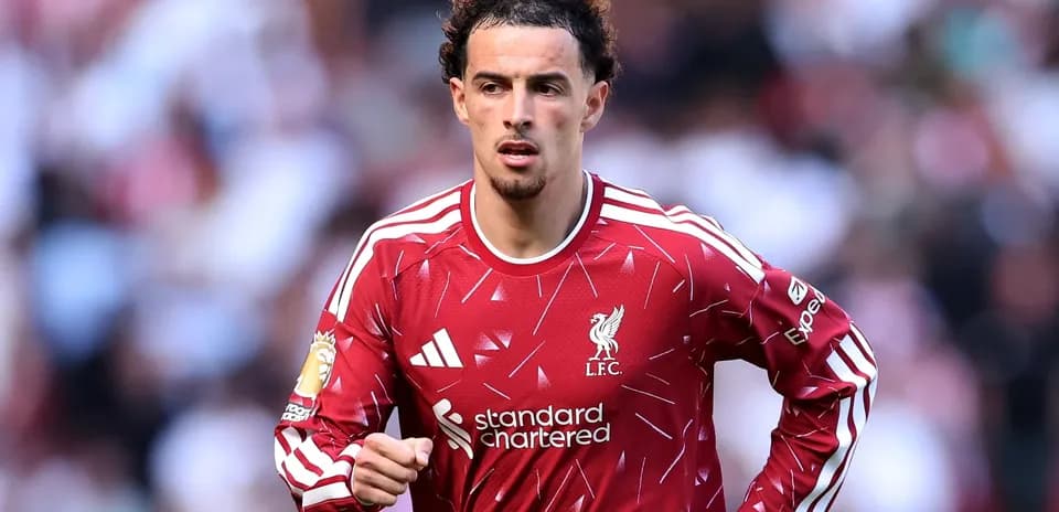 Player in Liverpool FC jersey running on field
