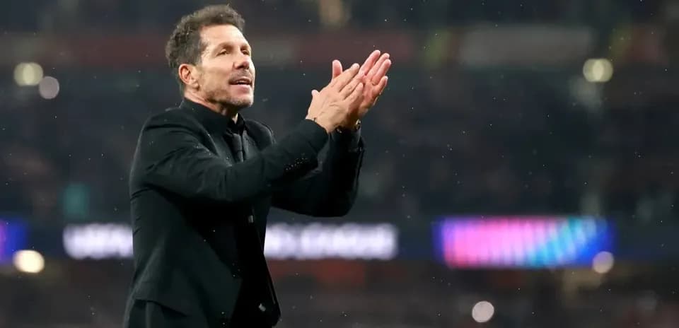 Manager applauding fans during a match