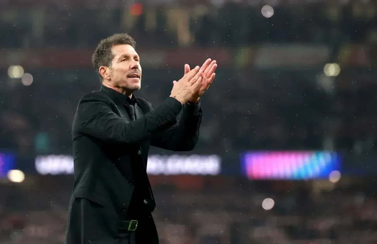 Manager applauding fans during a match