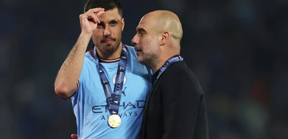 Player and coach celebrating with medals post-match