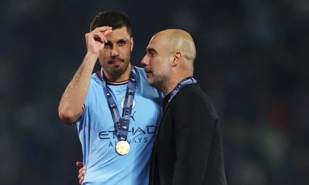 Player and coach celebrating with medals post-match
