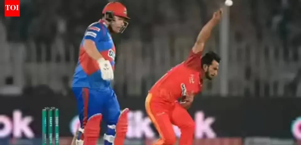 Bowler delivering ball while batsman watches closely