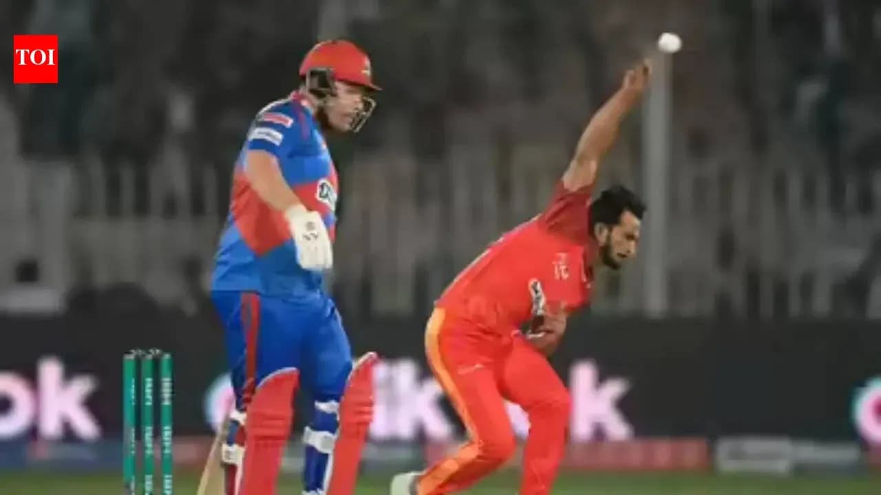 Bowler delivering ball while batsman watches closely