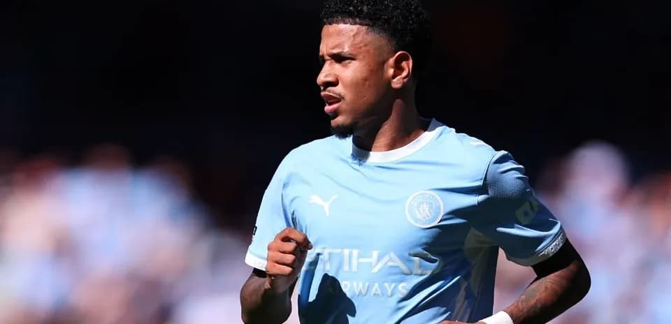 Player running on the pitch in light blue jersey