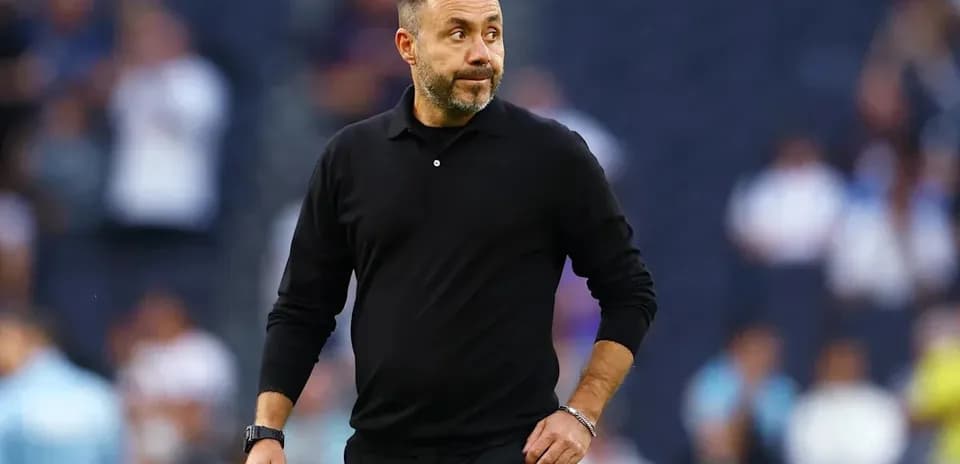 Coach walking along the sideline during match