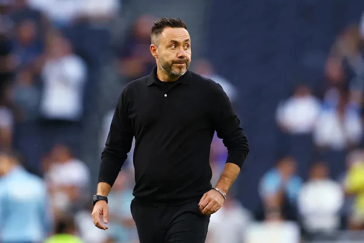 Coach walking along the sideline during match
