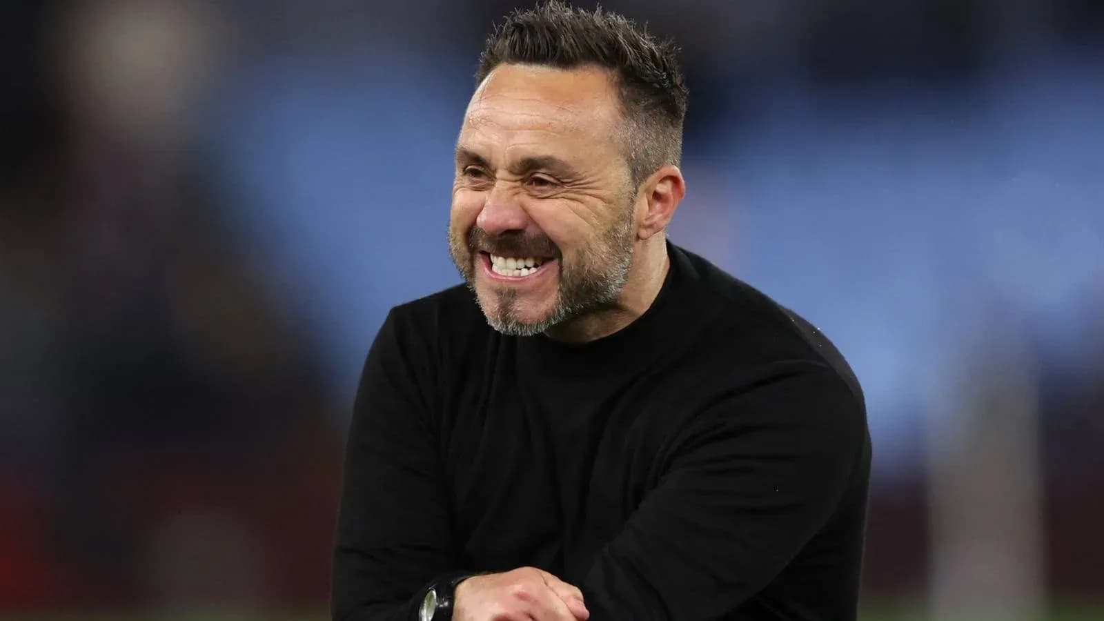 Coach celebrating during a match on the sidelines