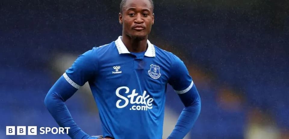 Everton player posing in blue kit during match