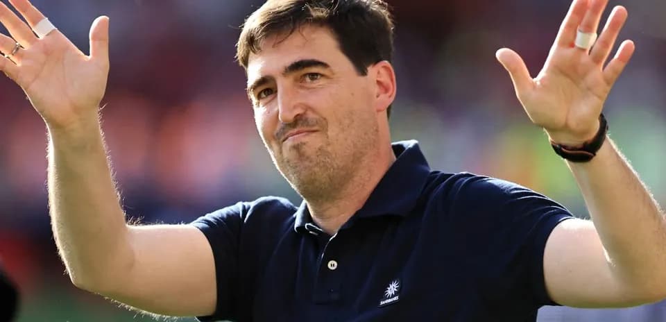 Man gesturing with hands during sporting event