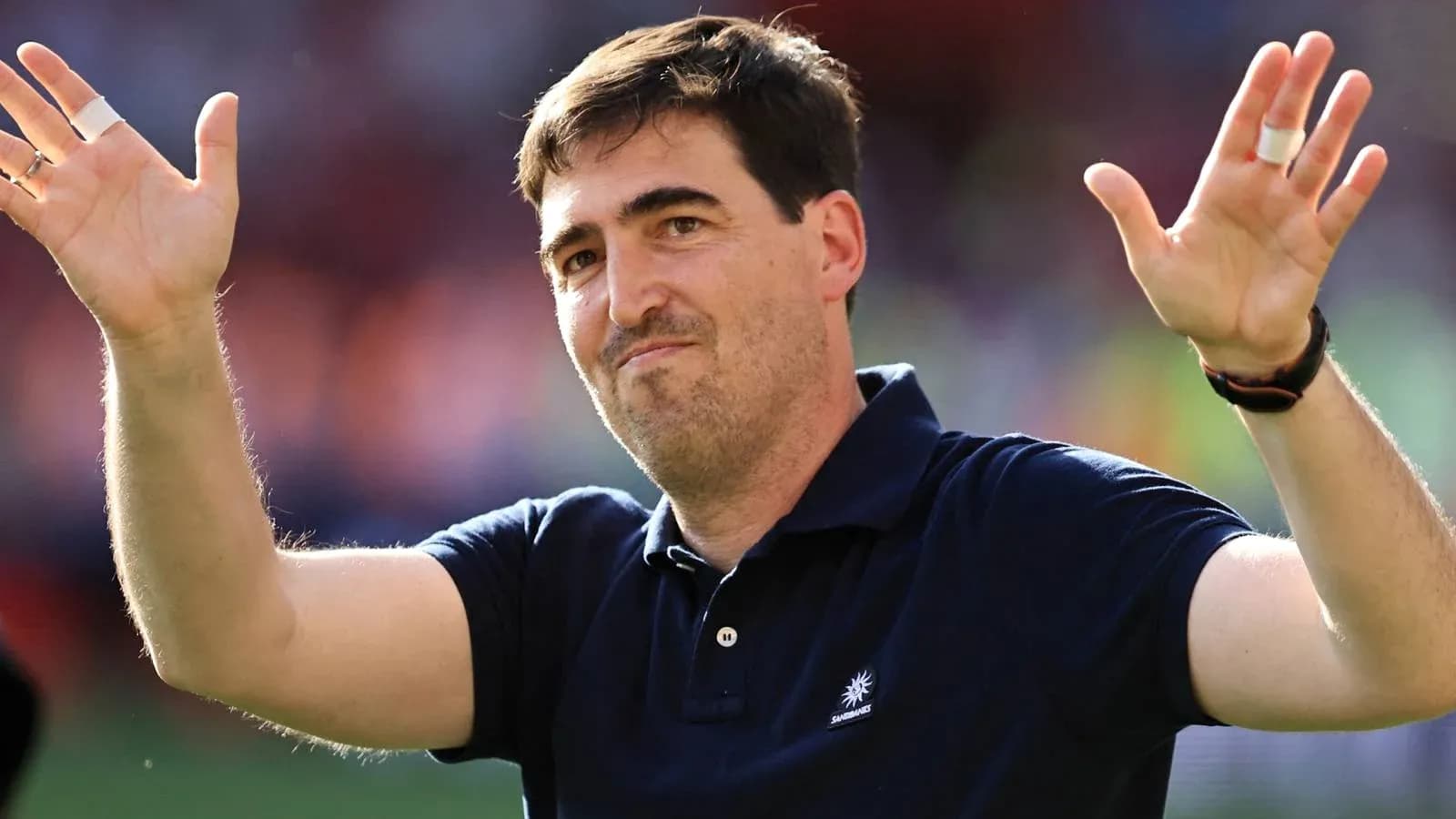 Man gesturing with hands during sporting event