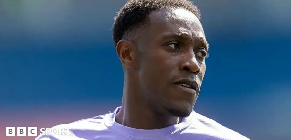Football player wearing a purple jersey during warm-up