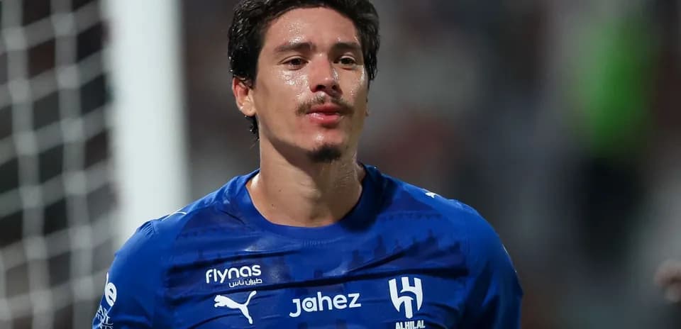 Player wearing blue jersey celebrating on the field