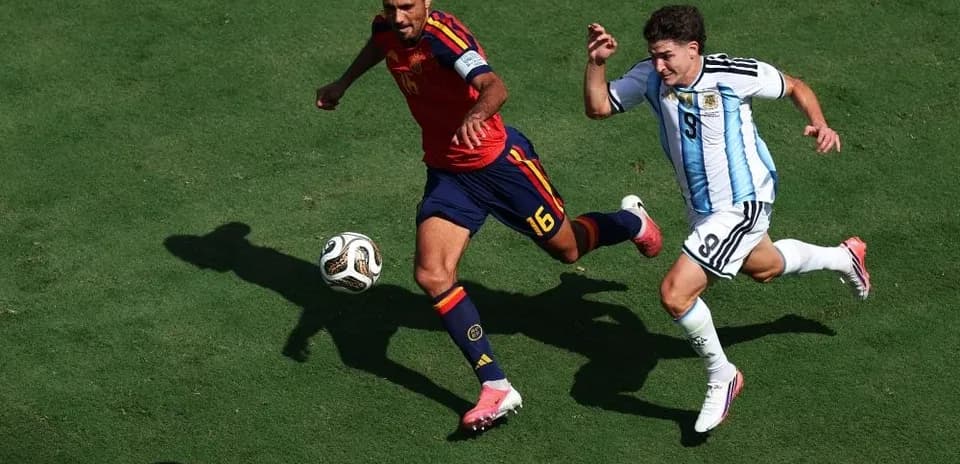 Two players competing for the ball on field