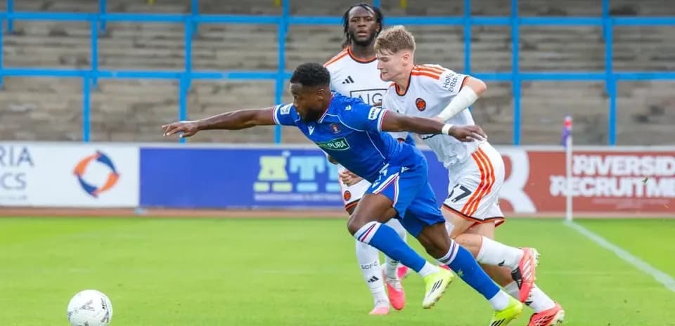 Player in blue shirt diving for the ball