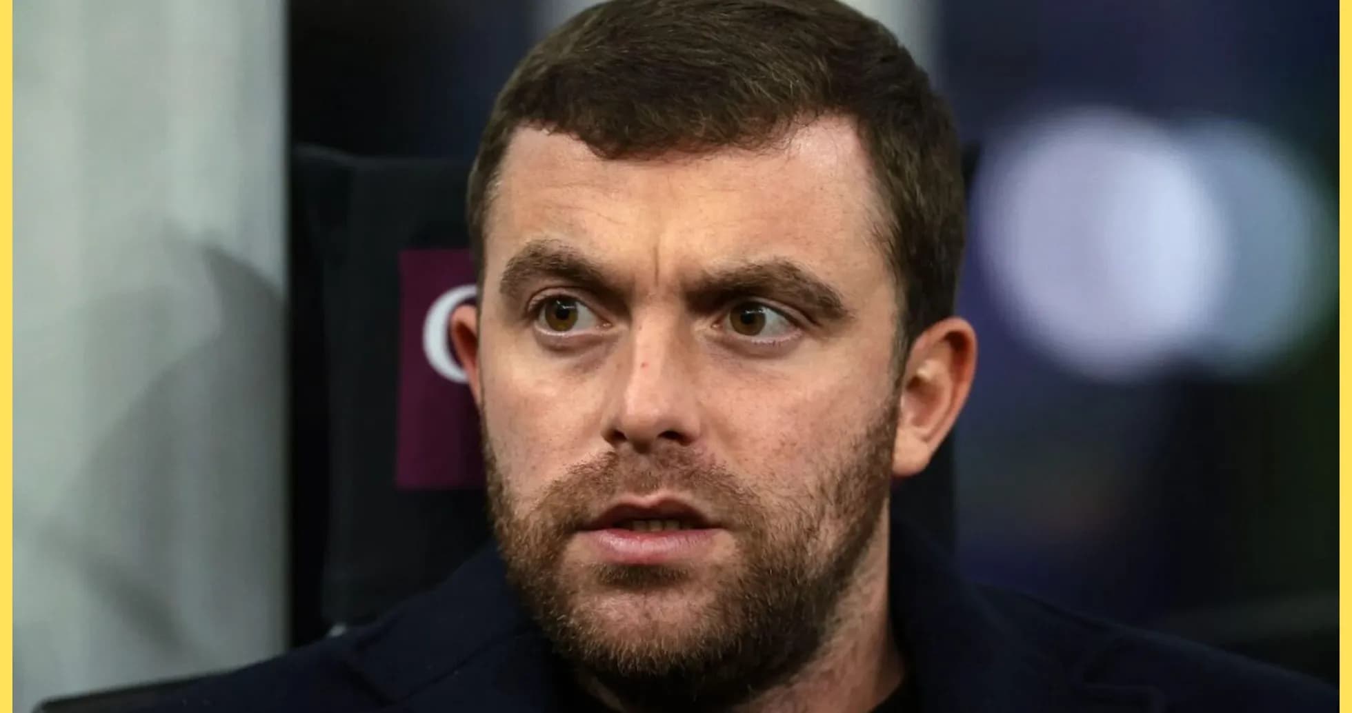 Close-up of a man with a beard and serious expression
