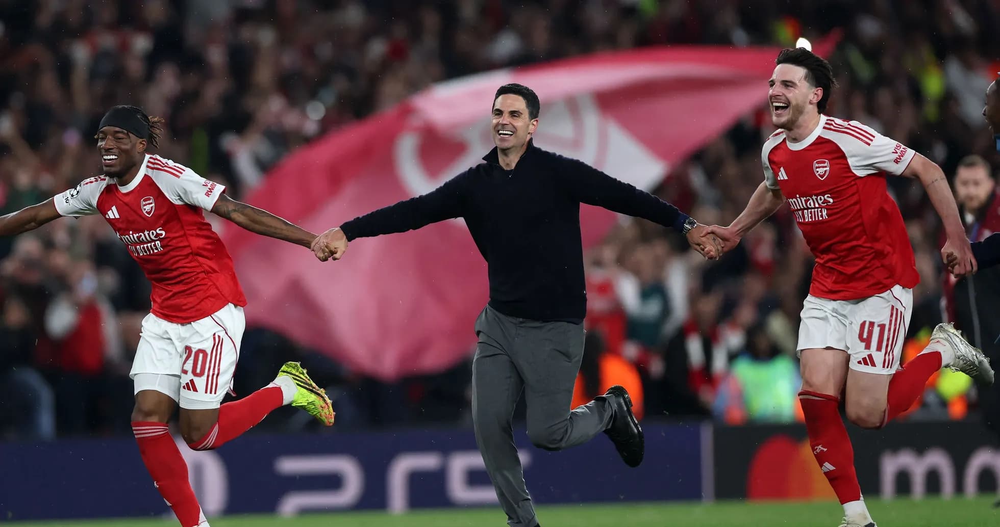 Arsenal players and coach celebrating victory on pitch