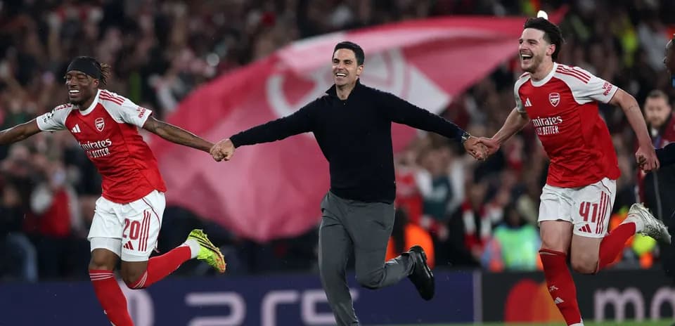 Arsenal players and coach celebrating victory on pitch