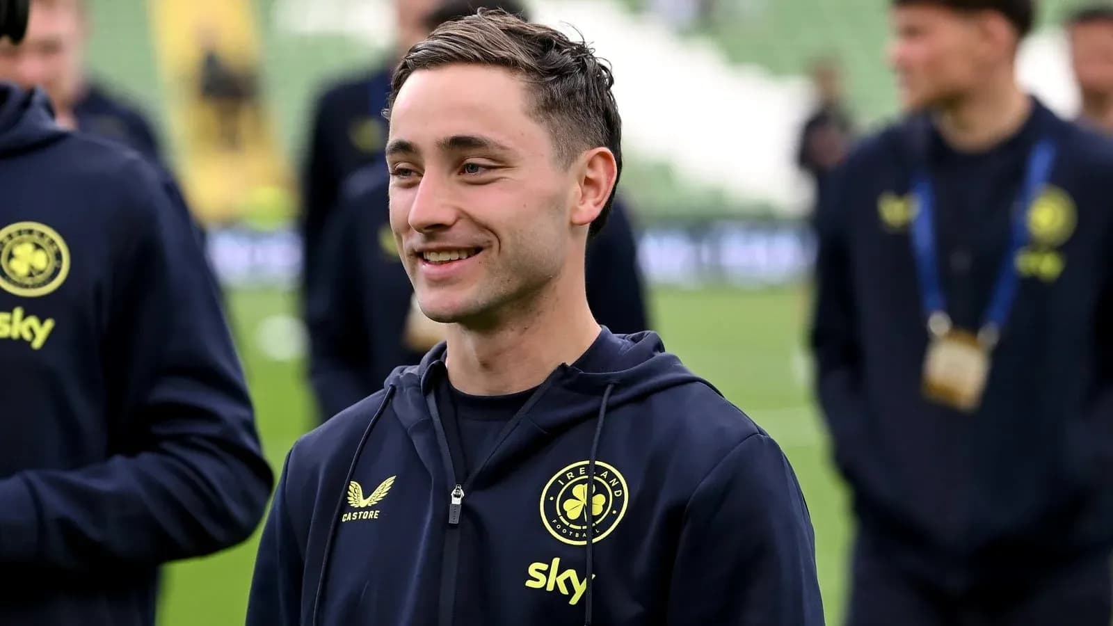 Player smiling while warming up on the pitch