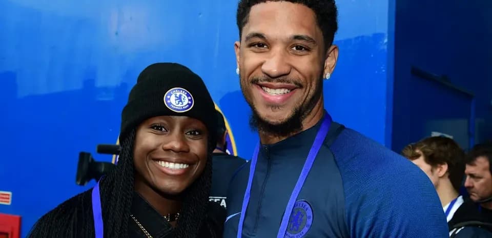 Two individuals smiling in Chelsea apparel