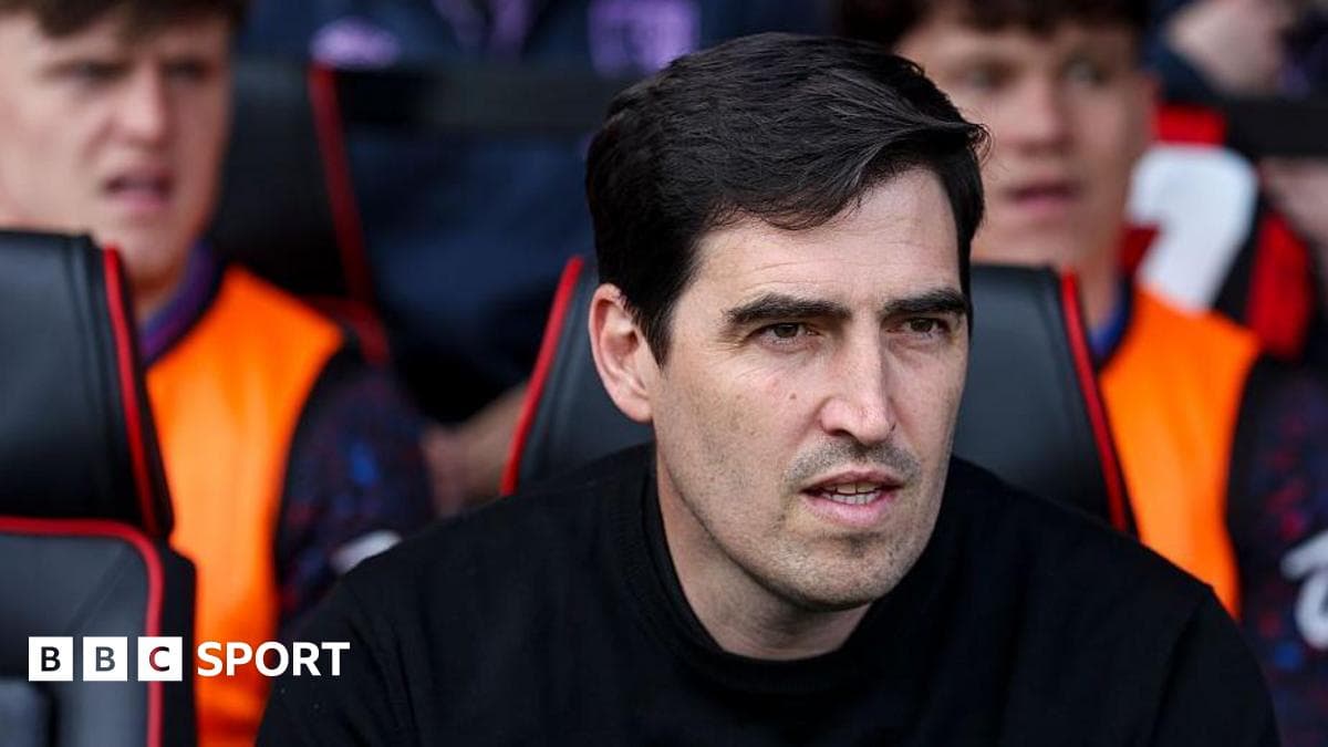 Coach observing from the sidelines during match